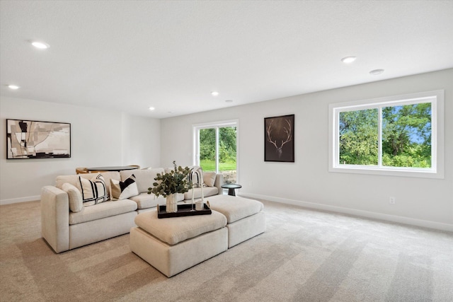 carpeted living room featuring recessed lighting and baseboards