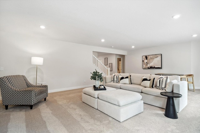 carpeted living room with stairs, baseboards, and recessed lighting