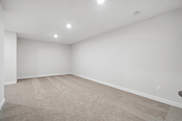 carpeted spare room with recessed lighting and baseboards