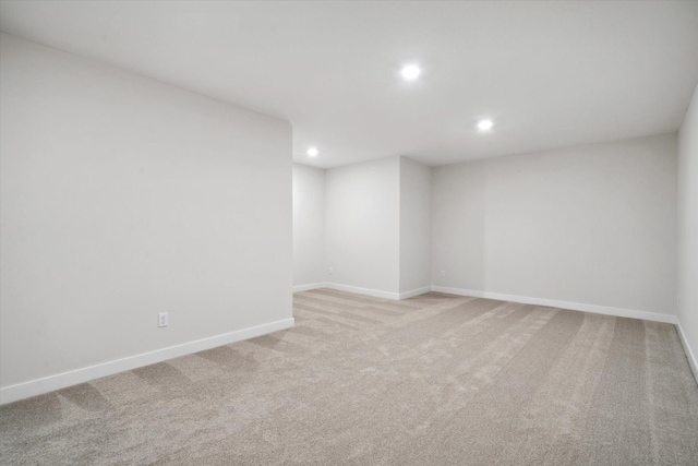 empty room with recessed lighting, light carpet, and baseboards