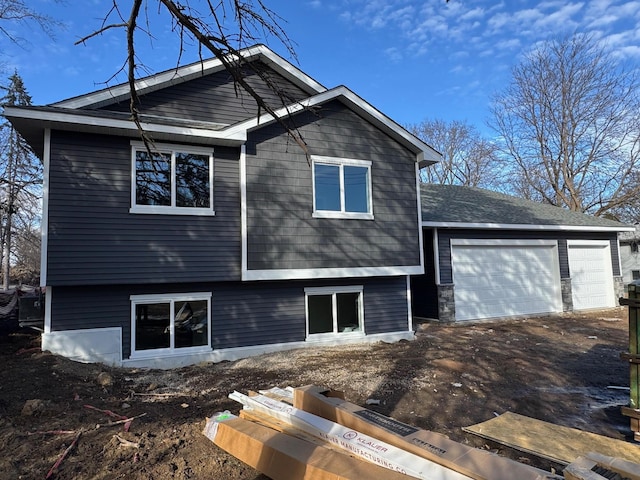 back of property featuring a garage