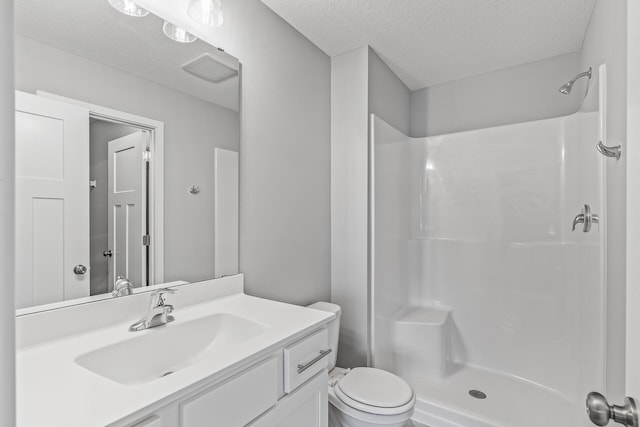 bathroom featuring a stall shower, visible vents, a textured ceiling, and vanity