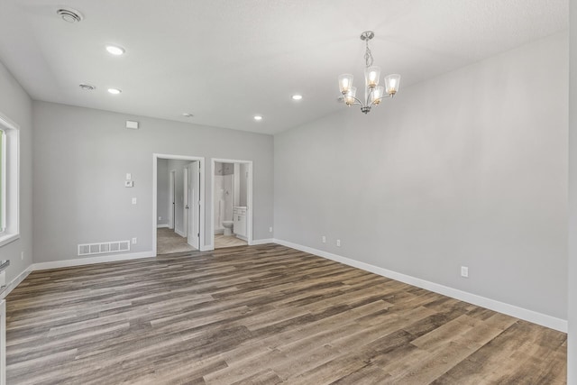 spare room featuring recessed lighting, visible vents, baseboards, and wood finished floors