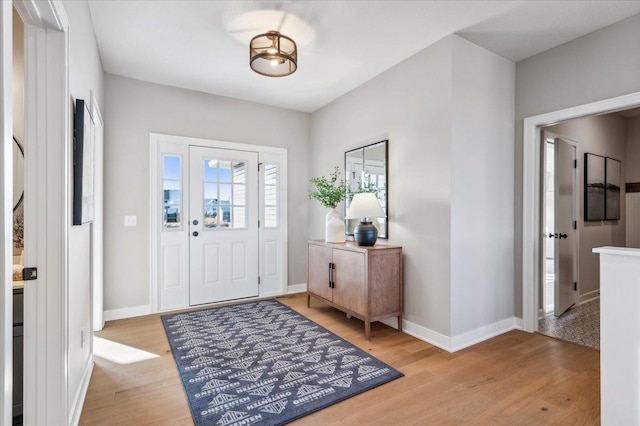 entryway with light wood-type flooring and baseboards