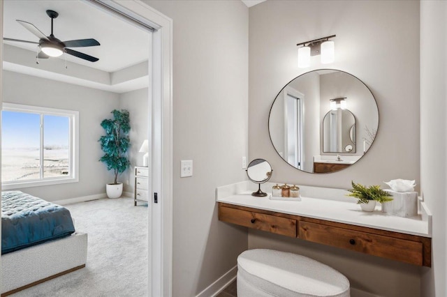 bathroom with ceiling fan and baseboards