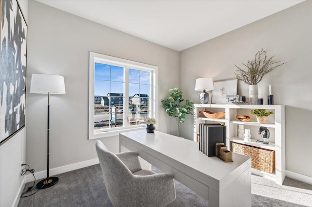 carpeted office space featuring baseboards