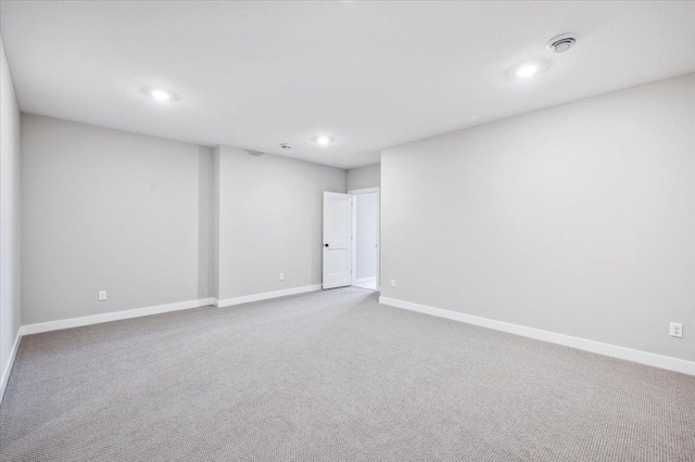 carpeted spare room with recessed lighting and baseboards