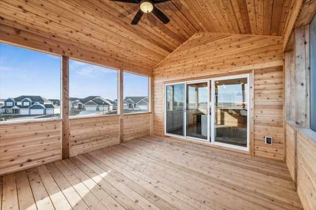 unfurnished sunroom featuring vaulted ceiling, a residential view, wood ceiling, and a ceiling fan