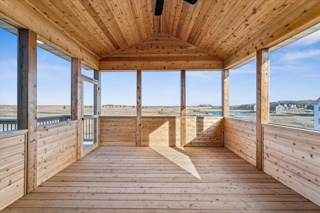 unfurnished sunroom with a ceiling fan, a wealth of natural light, wood ceiling, and vaulted ceiling