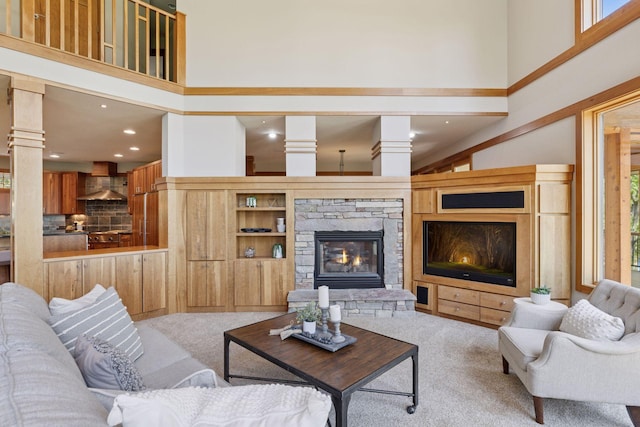 6 Black Lake Rd, North Oaks, MN 55127 - living area featuring a towering ceiling, a fireplace, carpet flooring, ornate columns, and recessed lighting