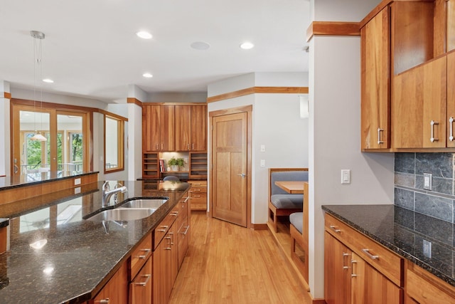 6 Black Lake Rd, North Oaks, MN 55127 - kitchen with a sink, brown cabinetry, light wood-type flooring, decorative backsplash, and recessed lighting