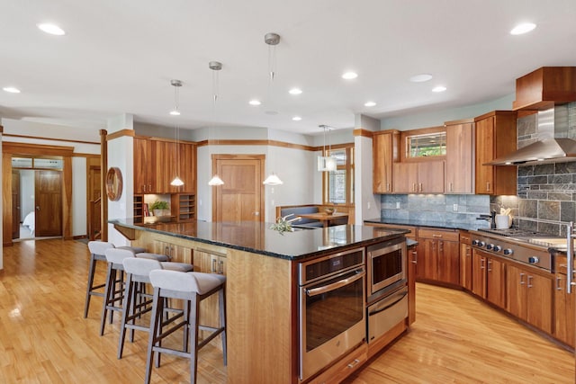 6 Black Lake Rd, North Oaks, MN 55127 - kitchen featuring a warming drawer, appliances with stainless steel finishes, light wood finished floors, decorative backsplash, and recessed lighting