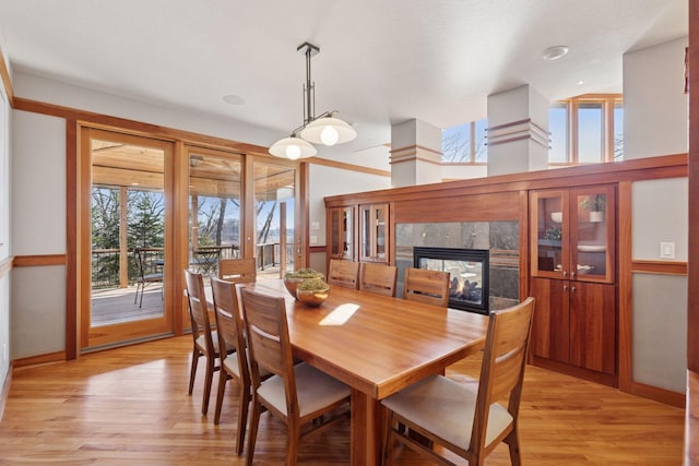 6 Black Lake Rd, North Oaks, MN 55127 - dining space with a premium fireplace, light wood finished floors, and baseboards