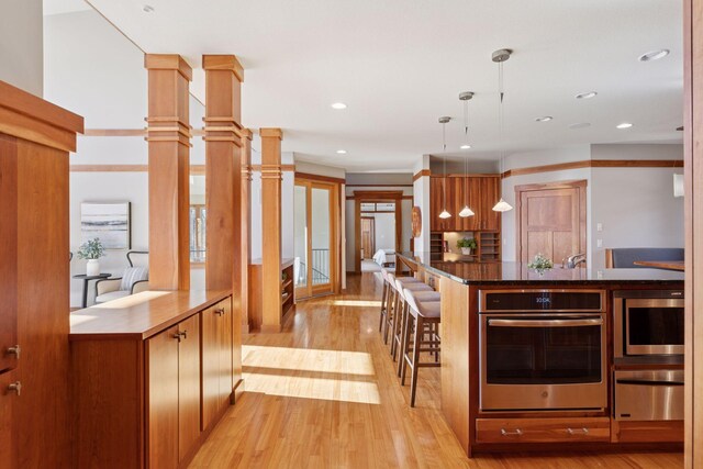 6 Black Lake Rd, North Oaks, MN 55127 - kitchen featuring stainless steel appliances, a warming drawer, light wood-style floors, recessed lighting, and a breakfast bar