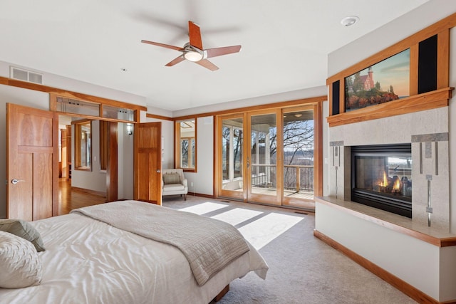 6 Black Lake Rd, North Oaks, MN 55127 - bedroom with access to exterior, a multi sided fireplace, and carpet