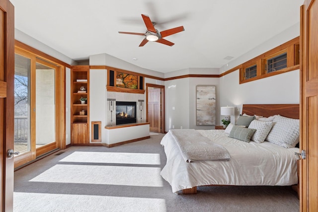 6 Black Lake Rd, North Oaks, MN 55127 - bedroom featuring a multi sided fireplace, carpet, access to outside, and ceiling fan