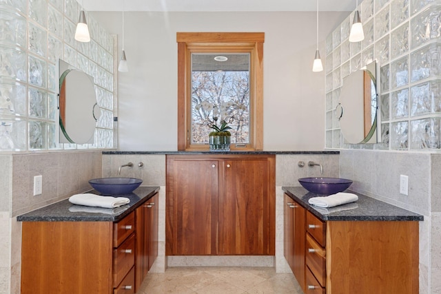 6 Black Lake Rd, North Oaks, MN 55127 - bathroom with tile walls, two vanities, plenty of natural light, and tile patterned floors