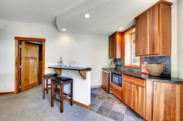6 Black Lake Rd, North Oaks, MN 55127 - kitchen featuring a breakfast bar, baseboards, brown cabinetry, black microwave, and recessed lighting