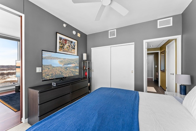 bedroom with visible vents, baseboards, a closet, and ceiling fan