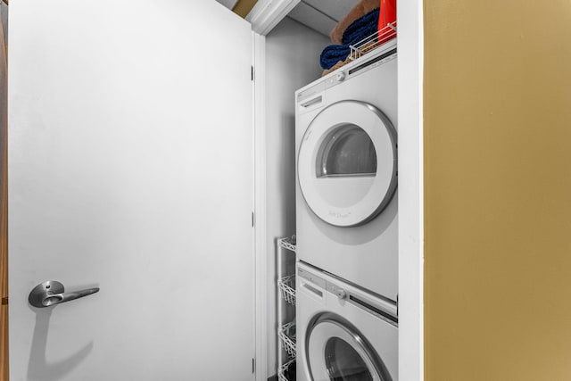 laundry room featuring laundry area and stacked washer / drying machine