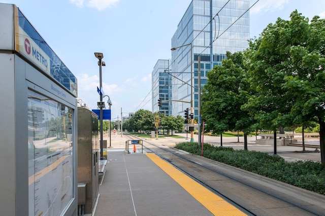 view of street featuring sidewalks, curbs, and street lights