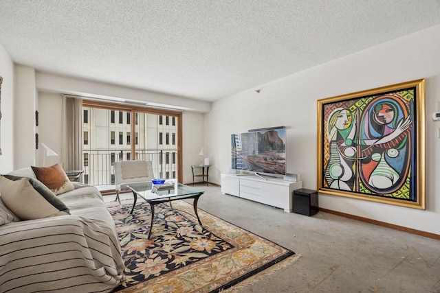 living room with a textured ceiling and baseboards