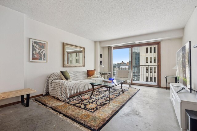 living area featuring a textured ceiling and baseboards