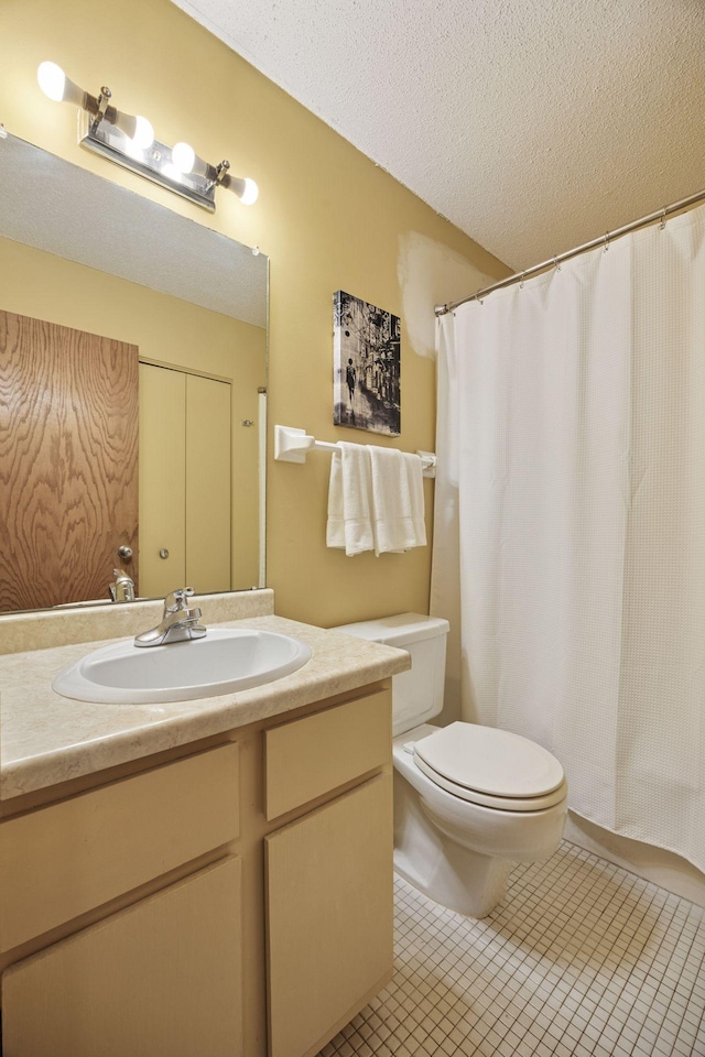 bathroom featuring toilet, a shower with curtain, tile patterned floors, a textured ceiling, and vanity