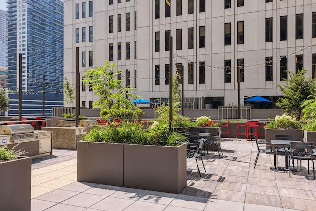 view of patio with a view of city and grilling area