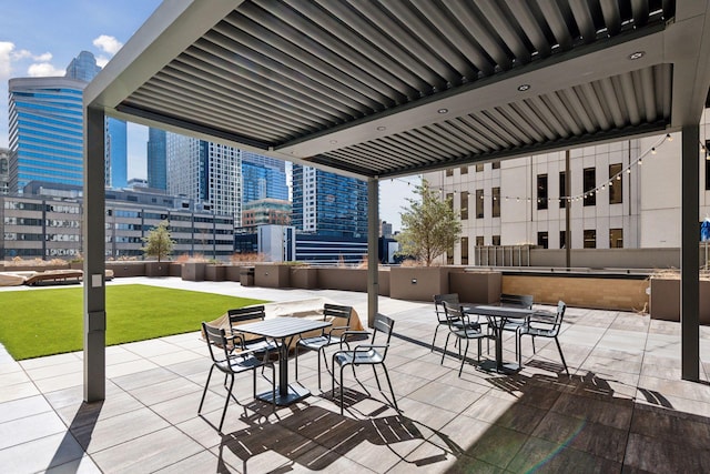 view of patio with a city view and outdoor dining space