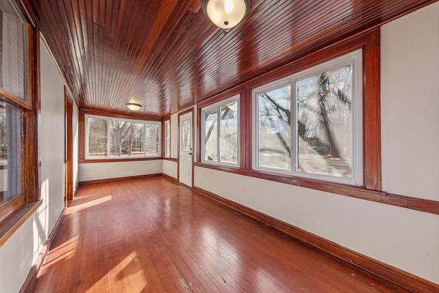 unfurnished sunroom with wood ceiling