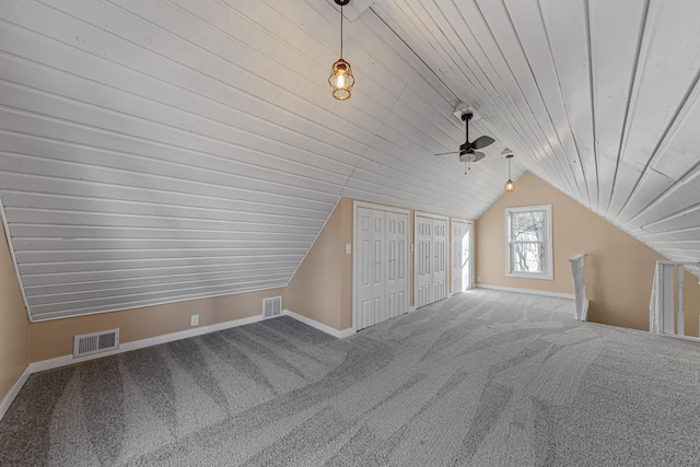 bonus room with lofted ceiling, baseboards, visible vents, and carpet flooring