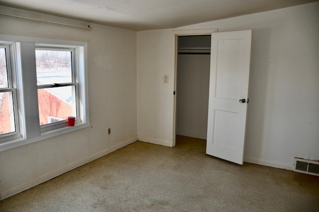 unfurnished bedroom with a closet, visible vents, and baseboards