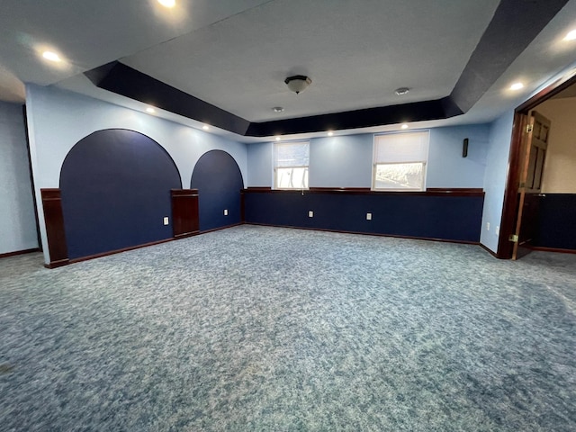 carpeted cinema featuring baseboards and a tray ceiling