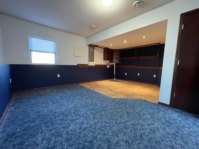 interior space with recessed lighting, carpet flooring, a textured ceiling, electric panel, and baseboards