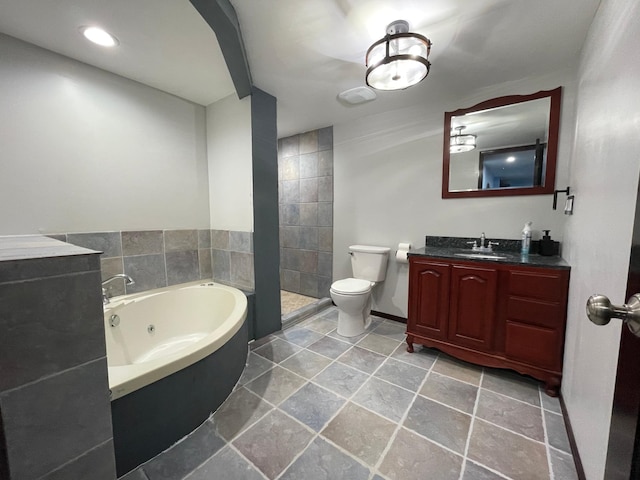 full bathroom featuring tiled shower, a jetted tub, vanity, and toilet