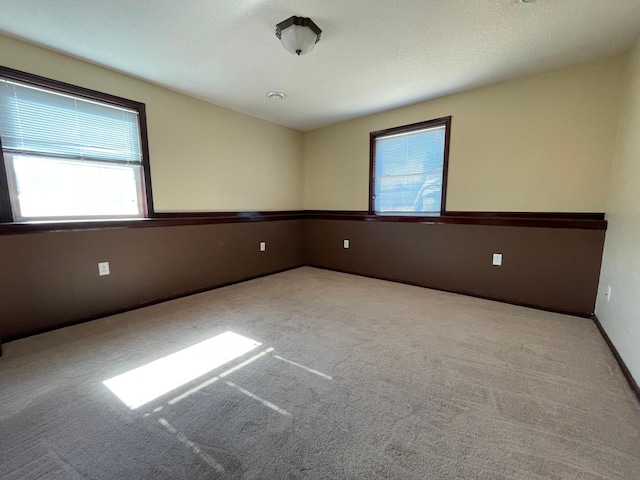 carpeted spare room with baseboards