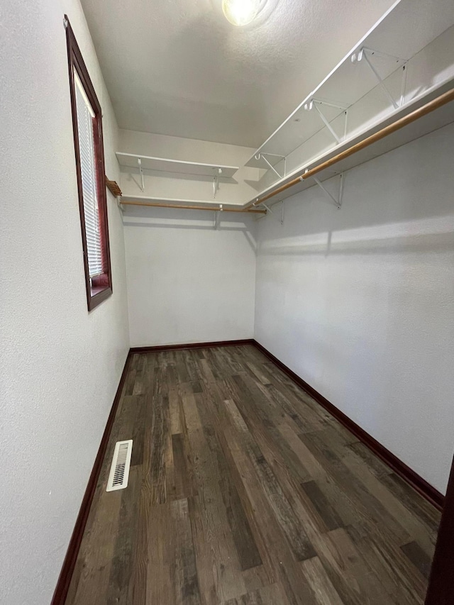 spacious closet featuring visible vents and wood finished floors