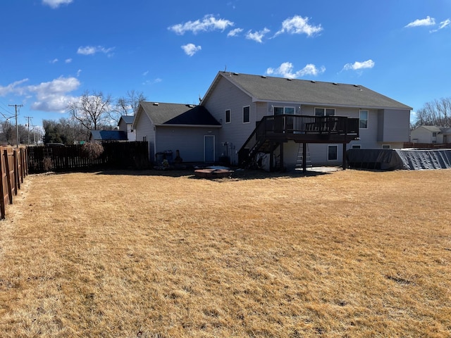 back of house with a deck, a yard, stairway, and fence