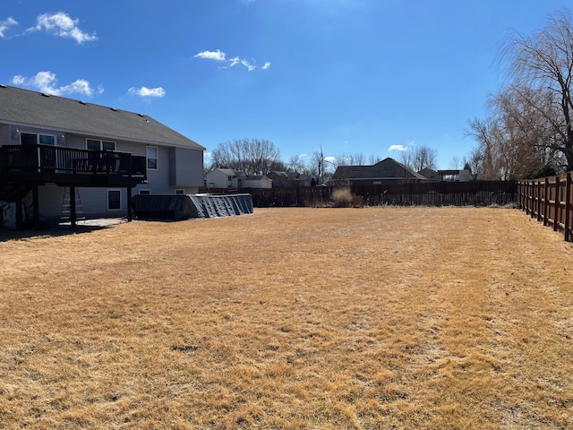 view of yard with a fenced backyard and a deck