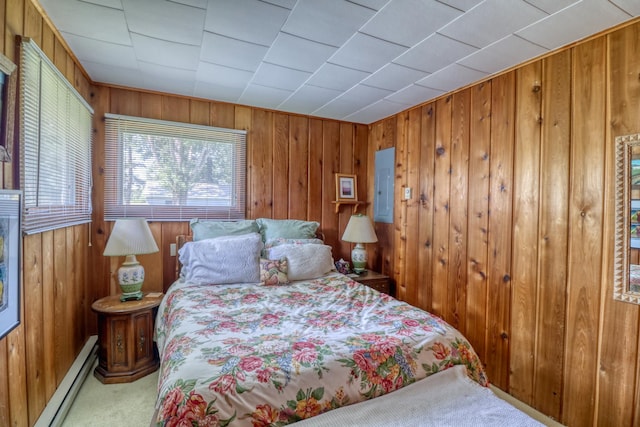 carpeted bedroom featuring baseboard heating, electric panel, and wooden walls