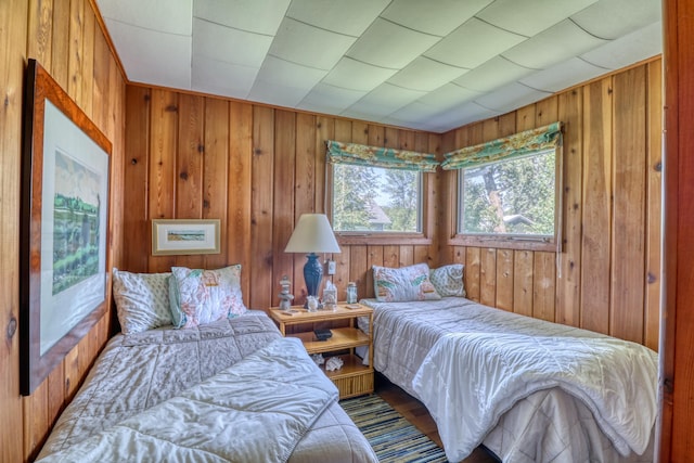 bedroom featuring wooden walls