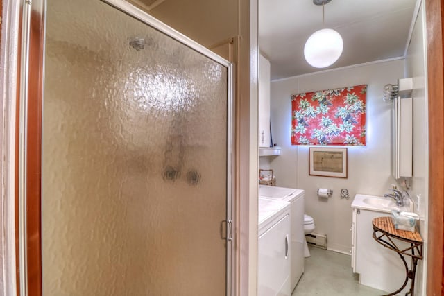 bathroom featuring a stall shower, toilet, vanity, and washer and clothes dryer