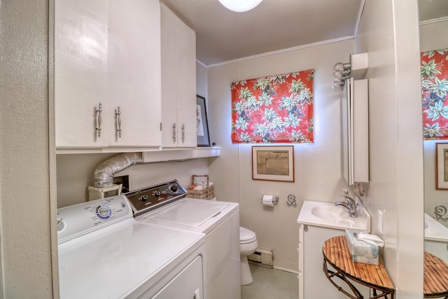 washroom featuring a baseboard radiator, a sink, baseboards, washer and dryer, and crown molding