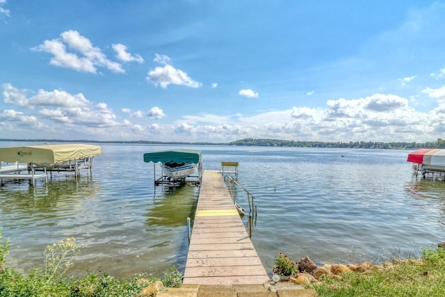 dock area with a water view and boat lift