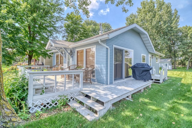 back of property with a lawn and a wooden deck