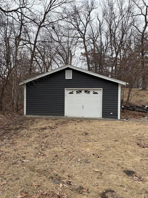 detached garage featuring driveway