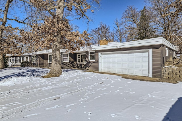 view of front of home with a chimney and an attached garage