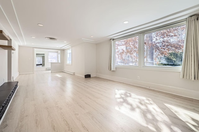 unfurnished living room featuring a baseboard heating unit, light wood-type flooring, and baseboards