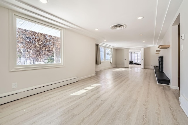 unfurnished living room featuring recessed lighting, visible vents, light wood-style flooring, baseboard heating, and baseboards